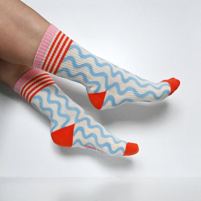 The Wave Crew Sock in orange, a ribbed knit crew sock made in North Carolina